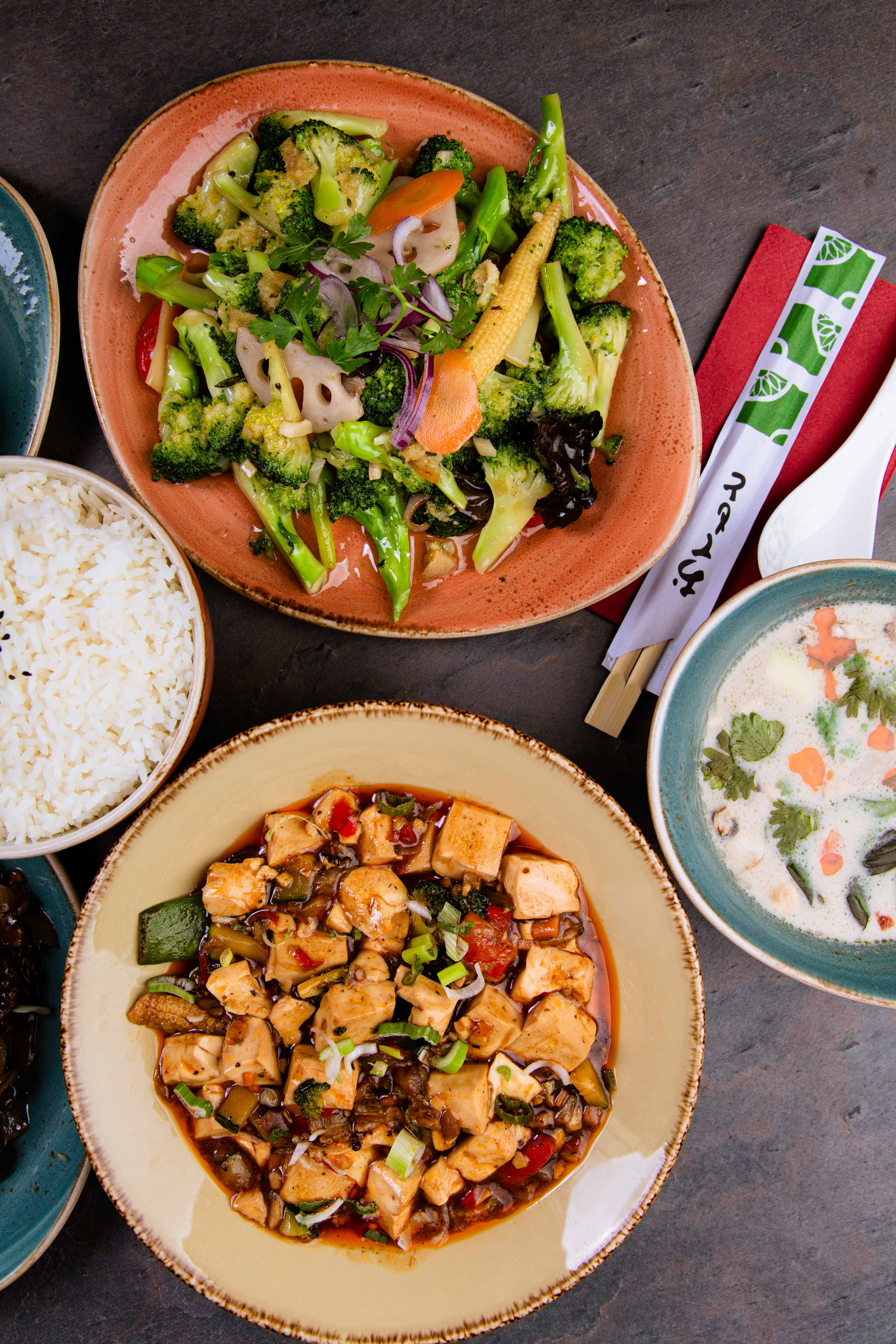 Mapo tofu with vegetables in a dark sauce and a brokkoli dish.